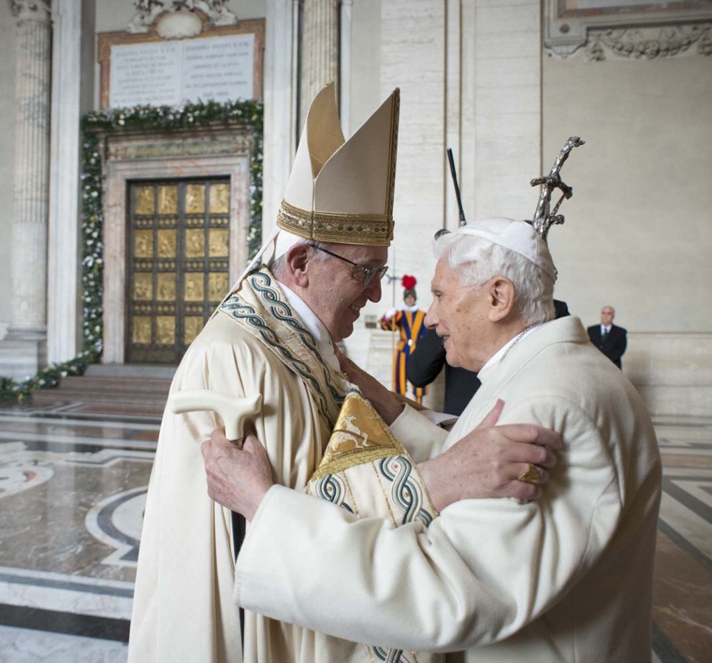 Pope Francis (L) embraces Emeritus Pope Benedict XVI before opening the Holy Door to mark opening of the Catholic Holy Year, or Jubilee, in St. Peter's Basilica, at the Vatican, December 8, 2015. REUTERS/Osservatore Romano/Handout via Reuters ATTENTION EDITORS - THIS IMAGE WAS PROVIDED BY A THIRD PARTY. REUTERS IS UNABLE TO INDEPENDENTLY VERIFY THE AUTHENTICITY, CONTENT, LOCATION OR DATE OF THIS IMAGE. IT IS DISTRIBUTED EXACTLY AS RECEIVED BY REUTERS, AS A SERVICE TO CLIENTS. FOR EDITORIAL USE ONLY. NOT FOR SALE FOR MARKETING OR ADVERTISING CAMPAIGNS. NO RESALES. NO ARCHIVE.